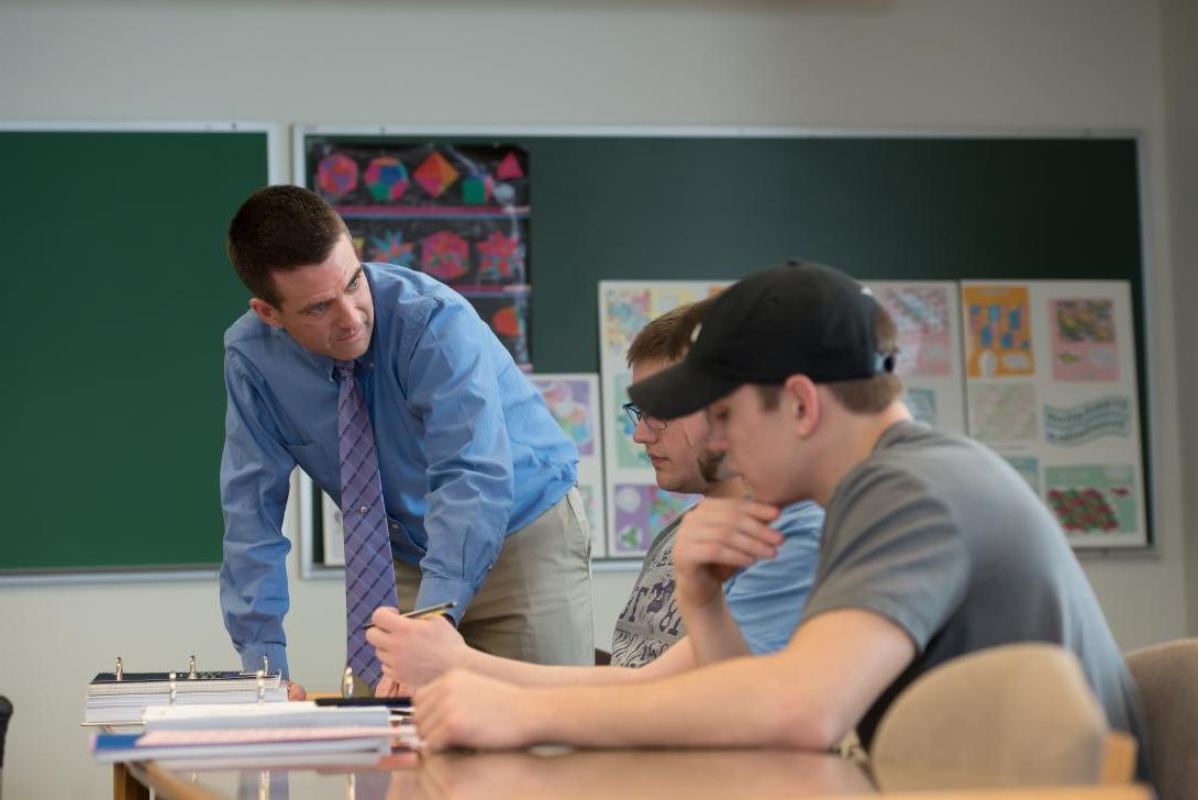 Math instructor, Chris Swanson, shows students how to work a problem